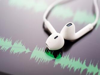 pair of headpones against soundwaves